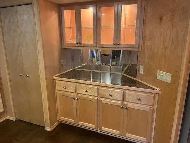 Slide: The Image of 2007 Thoroughbred Houseboat interior with wooden cabinets and mirrored backsplash. - 11