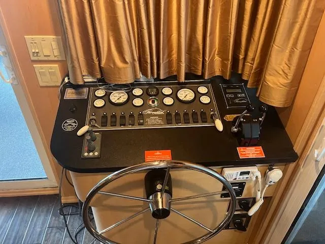 Slide: The Image of Control panel of a 2007 Thoroughbred houseboat with steering wheel and gauges. - 2