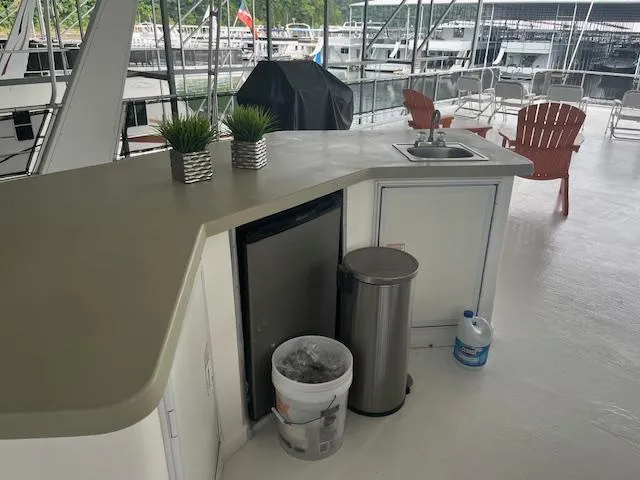 Slide: The Image of Outdoor kitchen area on a 2007 Thoroughbred Houseboat with sink, mini-fridge, and seating. - 33