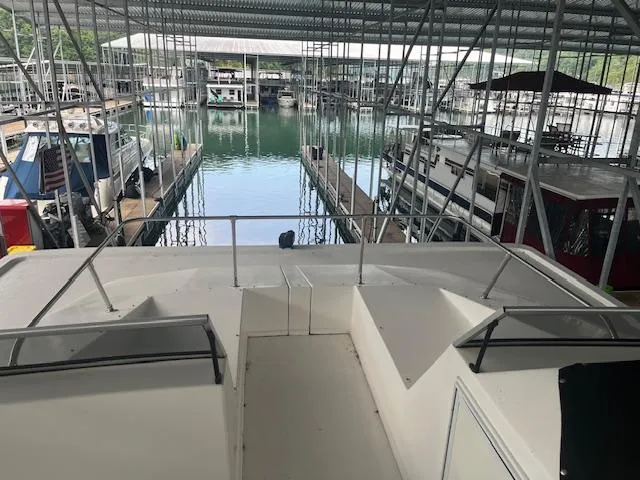 Slide: The Image of 2007 Thoroughbred Houseboat docked in a marina with covered slips. - 36