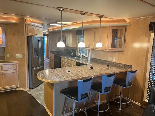 Slide: The Image of 2007 Thoroughbred houseboat kitchen with modern appliances and breakfast bar. - 7