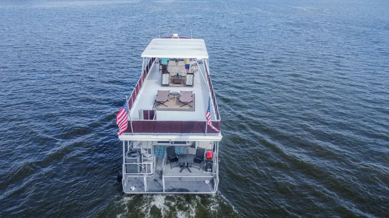 Slide: The Image of Sumerset 75 houseboat from 2002 cruising on open water, rear view. - 11