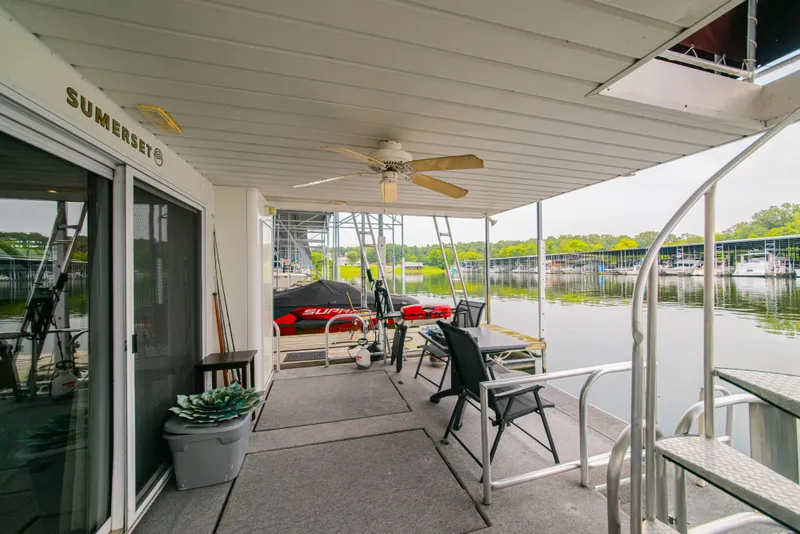 Slide: The Image of 2002 Sumerset 75 houseboat deck with chairs, table, and lake view. - 12