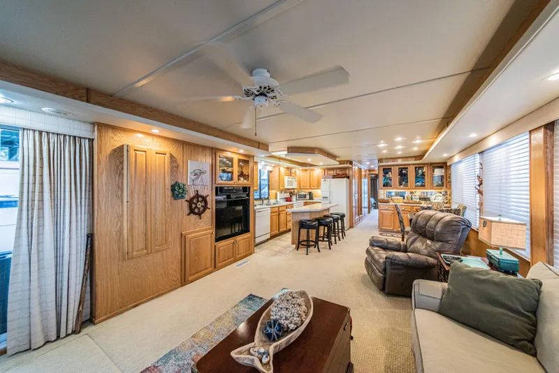 Slide: The Image of Spacious interior of 2002 Sumerset 75 houseboat with modern kitchen and cozy living area. - 14