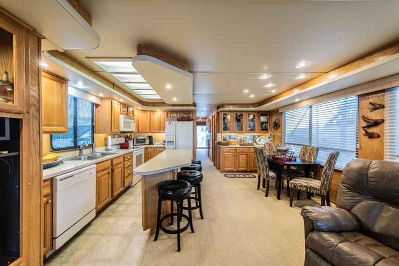 Slide: The Image of Luxurious 2002 Sumerset 75 houseboat interior with modern kitchen and dining area. - 17