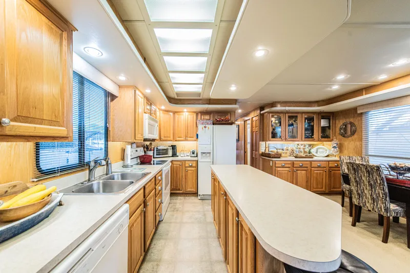 Slide: The Image of Spacious kitchen in 2002 Sumerset 75 houseboat with wooden cabinets and modern appliances. - 18