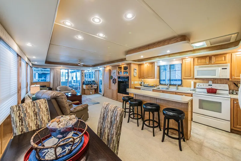 Slide: The Image of Luxurious 2002 Sumerset 75 houseboat interior with modern kitchen and cozy living area. - 21