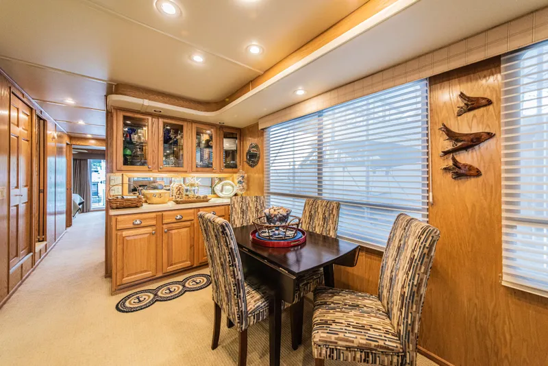Slide: The Image of Luxurious 2002 Sumerset 75 houseboat interior with dining area and wooden cabinetry. - 23