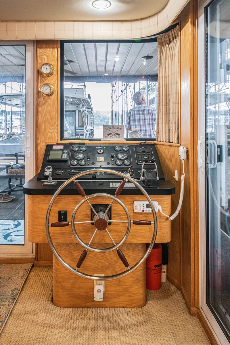 Slide: The Image of Interior helm of 2002 Sumerset 75 houseboat with steering wheel and control panel. - 25