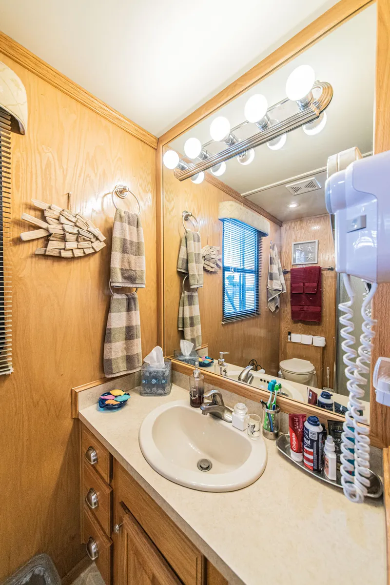 Slide: The Image of Bathroom interior of 2002 Sumerset 75 houseboat with wooden decor and modern amenities. - 27