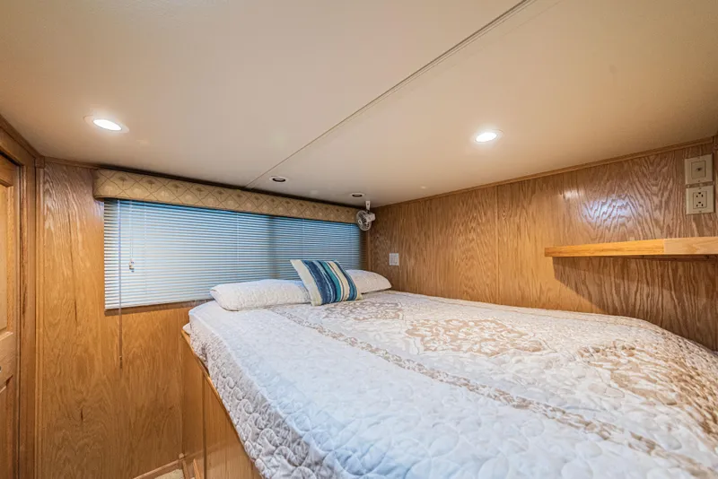 Slide: The Image of Cozy bedroom in 2002 Sumerset 75 houseboat with wood paneling and soft lighting. - 29