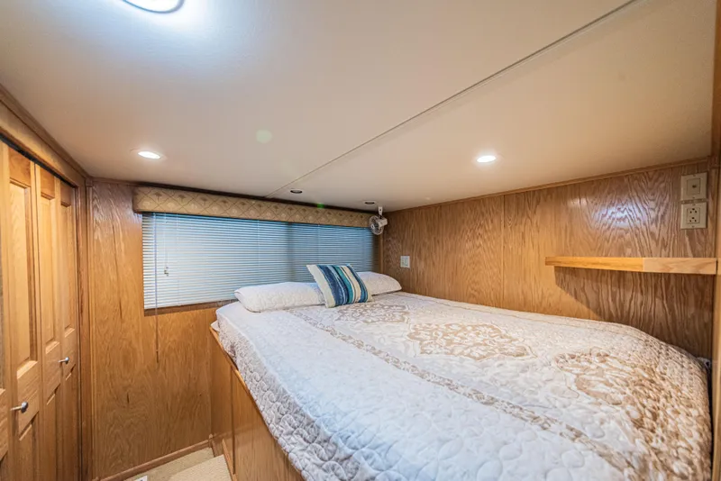 Slide: The Image of Cozy bedroom in 2002 Sumerset 75 houseboat with wood paneling and soft lighting. - 30