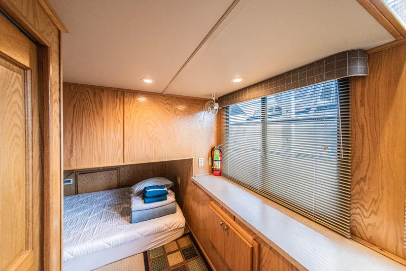 Slide: The Image of Cozy bedroom in 2002 Sumerset 75 houseboat with wood paneling and window blinds. - 31