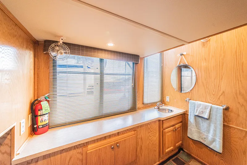 Slide: The Image of Interior of 2002 Sumerset 75 houseboat bathroom with wood paneling and sink. - 32