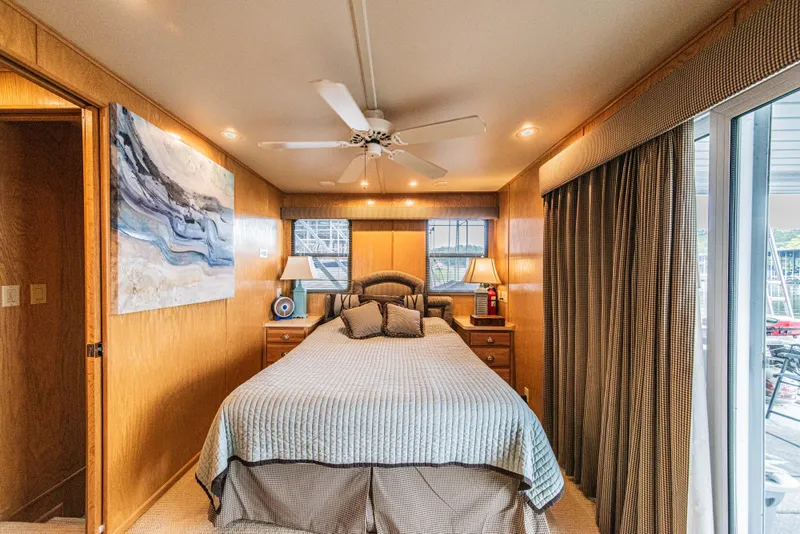 Slide: The Image of Luxurious bedroom interior of 2002 Sumerset 75 houseboat with modern decor and natural light. - 33
