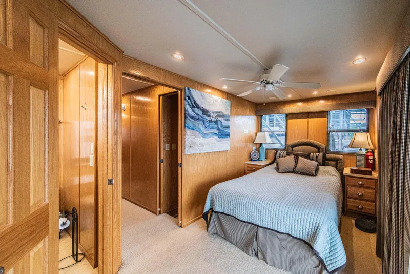 Slide: The Image of Luxurious bedroom interior in 2002 Sumerset 75 houseboat with wood paneling and cozy decor. - 34