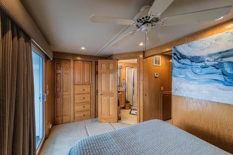 Slide: The Image of Cozy bedroom in 2002 Sumerset 75 houseboat with wood paneling and modern decor. - 35