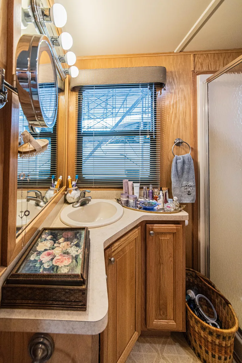 Slide: The Image of Luxurious bathroom in 2002 Sumerset 75 houseboat with wooden cabinetry and modern fixtures. - 38