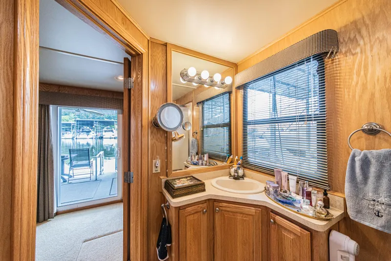 Slide: The Image of Bathroom interior of 2002 Sumerset 75 houseboat with wooden cabinetry and marina view. - 39