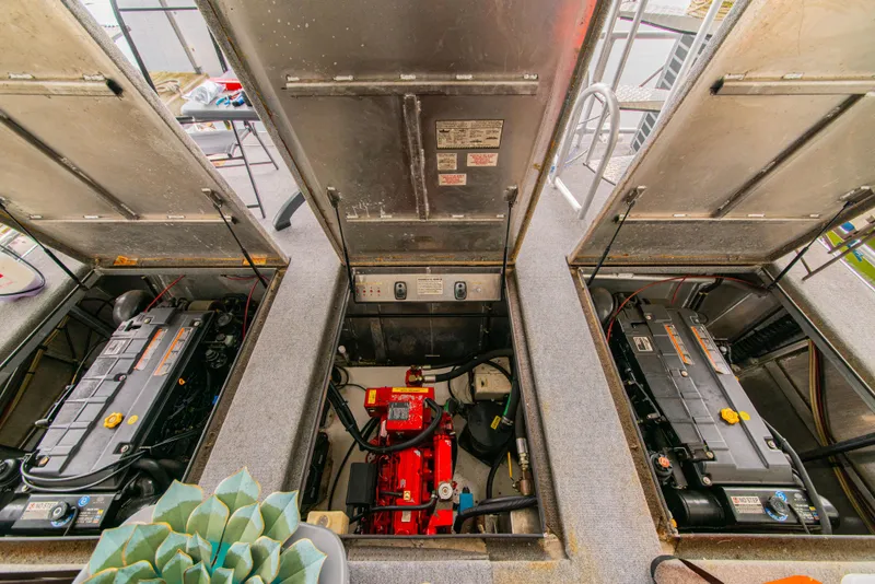 Slide: The Image of Engine compartment of a 2002 Sumerset 75 houseboat, showcasing dual engines and equipment. - 41