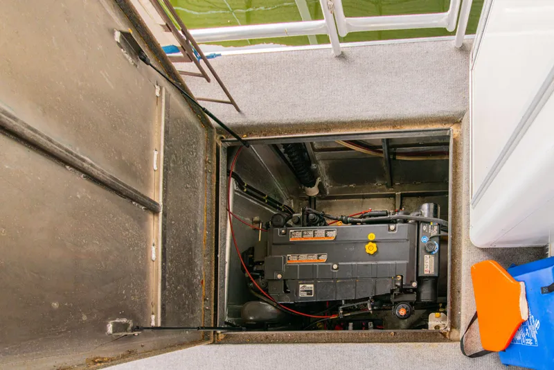 Slide: The Image of Engine compartment of a 2002 Sumerset 75 houseboat, showing mechanical components. - 43