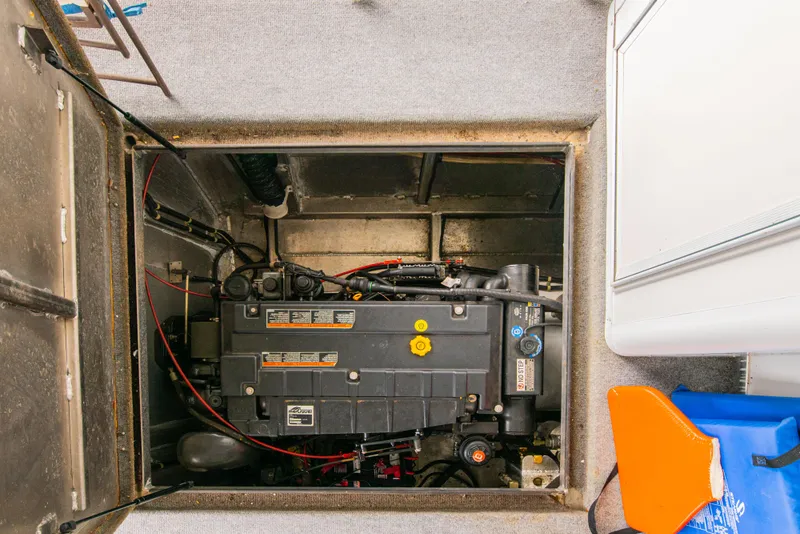 Slide: The Image of Engine compartment of a 2002 Sumerset 75 houseboat, featuring a well-maintained motor. - 44