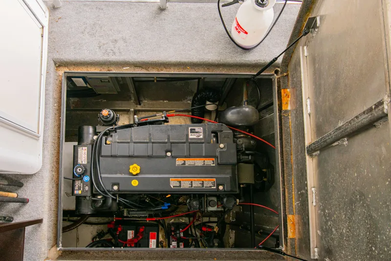 Slide: The Image of Engine compartment of a 2002 Sumerset 75 houseboat, featuring mechanical components and equipment. - 45