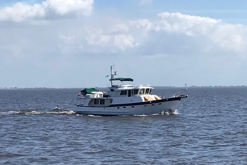 The Image of Kadey-Krogen 58 yacht cruising on open water under a partly cloudy sky, 2001 model. - 0