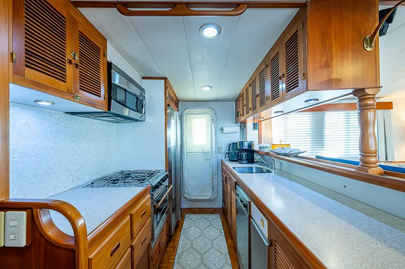 Slide: The Image of Luxurious 2001 Kadey-Krogen 58 yacht kitchen with wooden cabinetry and modern appliances. - 10