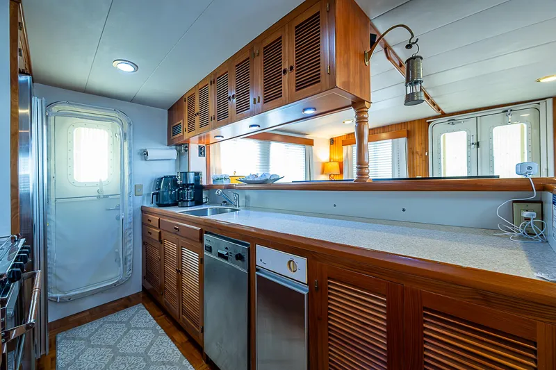 Slide: The Image of Luxurious 2001 Kadey-Krogen 58 yacht kitchen with wooden cabinetry and modern appliances. - 11
