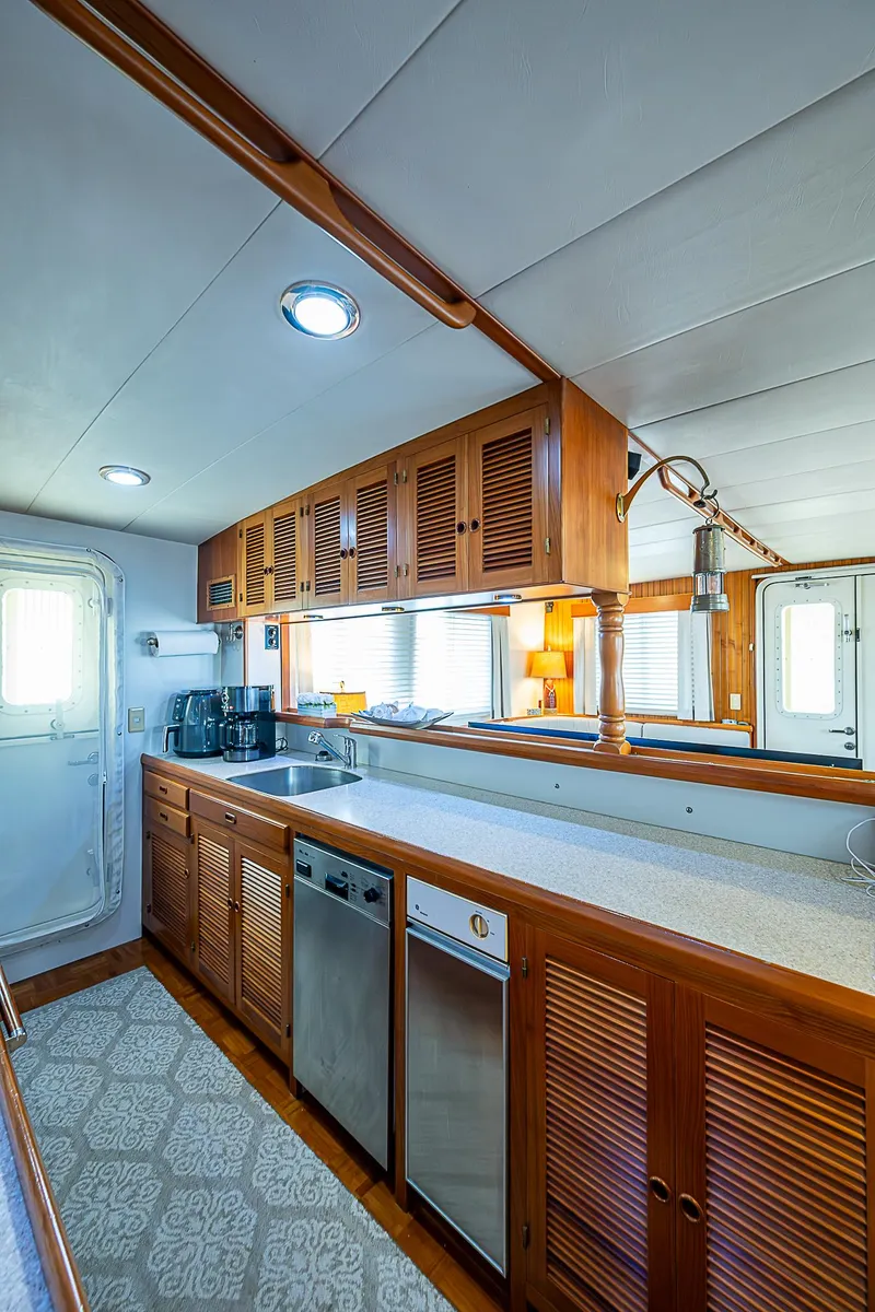 Slide: The Image of Spacious kitchen in 2001 Kadey-Krogen 58 yacht with wooden cabinets and modern appliances. - 12