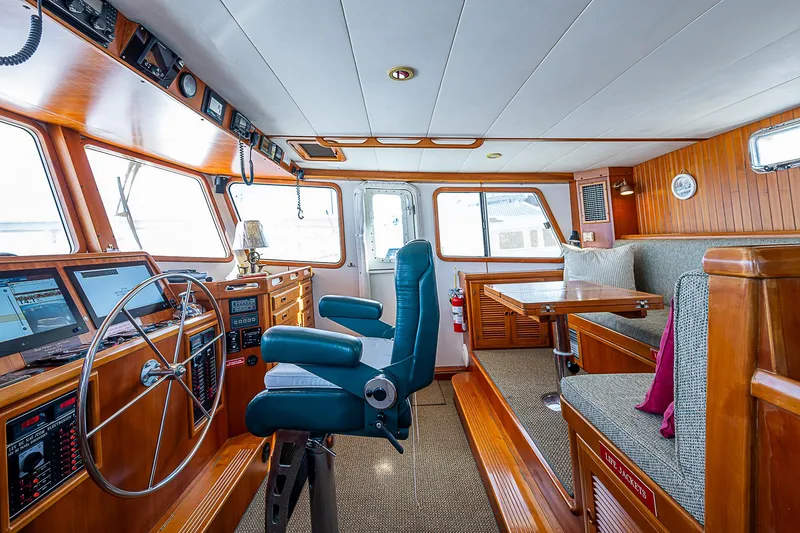 Slide: The Image of Pilothouse interior of 2001 Kadey-Krogen 58 yacht with wooden finishes and navigation equipment. - 16