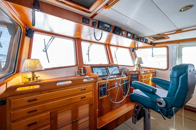 Slide: The Image of Pilothouse of 2001 Kadey-Krogen 58 yacht with wooden interior and captain's chair. - 17