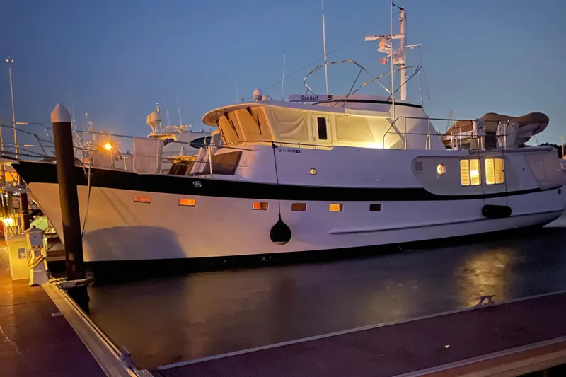 Slide: The Image of Kadey-Krogen 58 yacht, 2001 model, docked at sunset with lights on. - 2