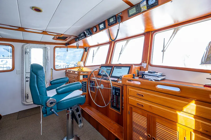 Slide: The Image of Pilothouse of 2001 Kadey-Krogen 58 yacht with wooden interior and navigation equipment. - 20