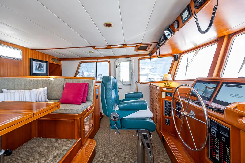 Slide: The Image of Pilothouse interior of 2001 Kadey-Krogen 58 yacht with helm and seating area. - 21