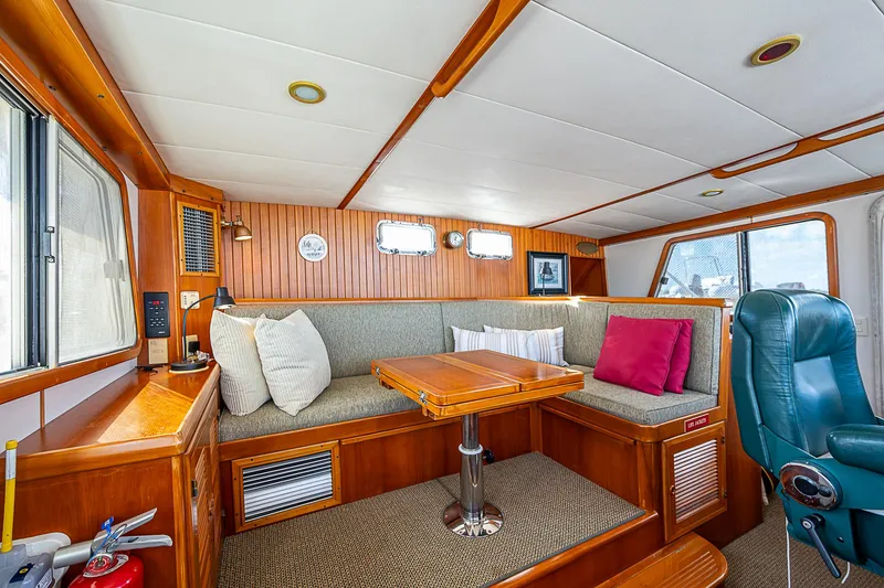 Slide: The Image of Interior of 2001 Kadey-Krogen 58 yacht with cozy seating and wooden accents. - 22