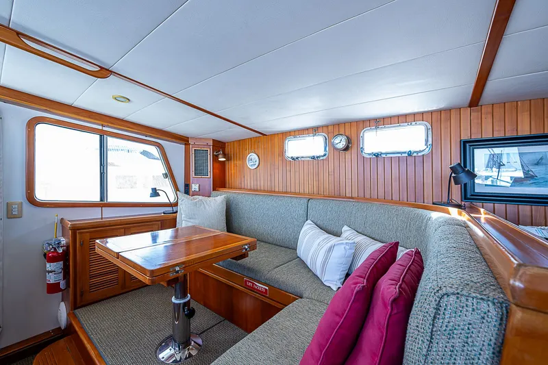 Slide: The Image of Cozy interior of 2001 Kadey-Krogen 58 yacht with wood paneling and cushioned seating. - 23