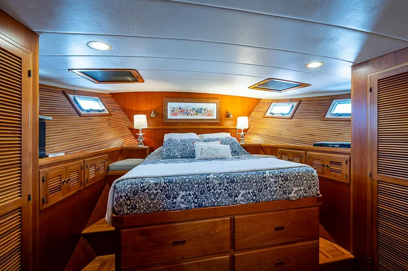 Slide: The Image of Luxurious 2001 Kadey-Krogen 58 yacht bedroom with wood paneling and cozy bedding. - 24