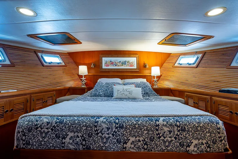 Slide: The Image of Luxurious bedroom interior of 2001 Kadey-Krogen 58 yacht with elegant wood paneling. - 25