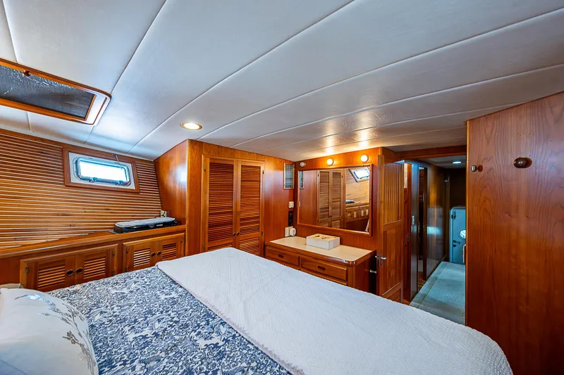 Slide: The Image of Luxurious wooden cabin interior of 2001 Kadey-Krogen 58 yacht with bed and vanity. - 26