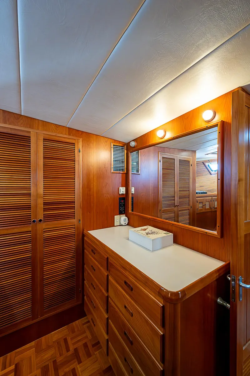 Slide: The Image of Kadey-Krogen 58 (2001) yacht interior with wooden cabinetry and mirror. - 28