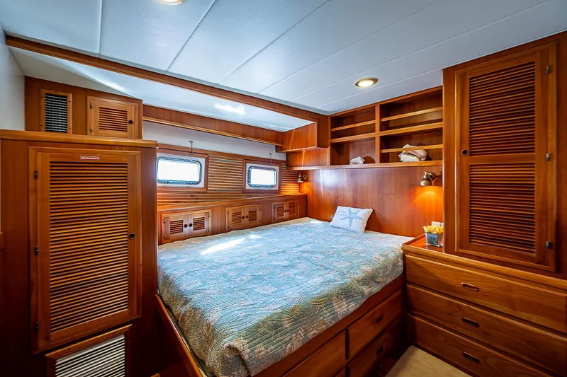 Slide: The Image of Luxurious wood-finished bedroom in 2001 Kadey-Krogen 58 yacht with ample storage and cozy lighting. - 35
