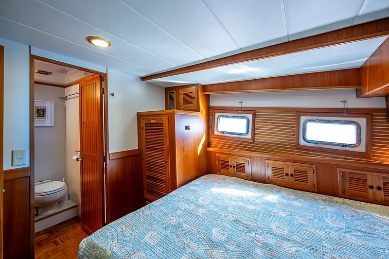 Slide: The Image of Luxurious 2001 Kadey-Krogen 58 yacht bedroom with wood paneling and ensuite bathroom. - 37