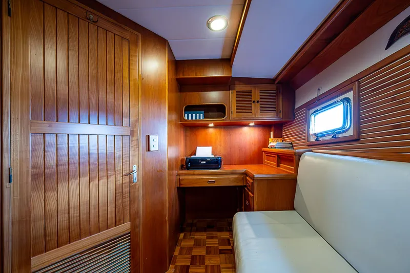 Slide: The Image of Luxurious wood-paneled cabin interior of 2001 Kadey-Krogen 58 yacht with desk and seating. - 42