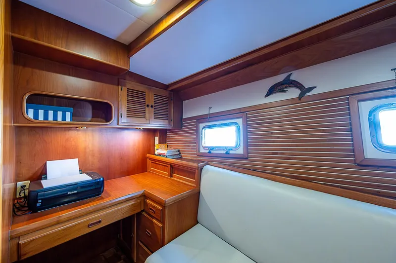 Slide: The Image of Luxurious wood-paneled cabin interior of a 2001 Kadey-Krogen 58 yacht with desk and seating. - 44