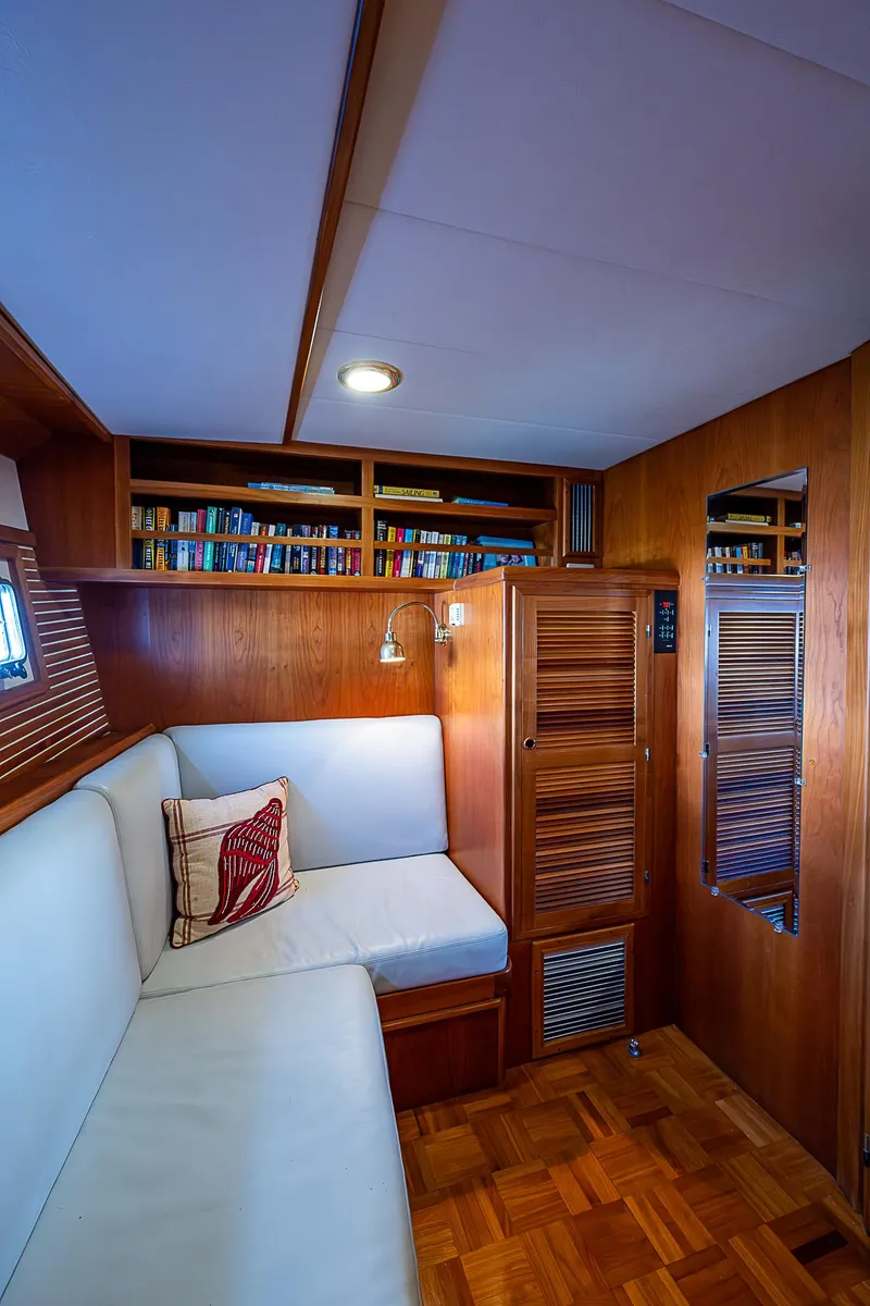 Slide: The Image of Cozy interior of 2001 Kadey-Krogen 58 yacht with wooden finishes and built-in bookshelves. - 46