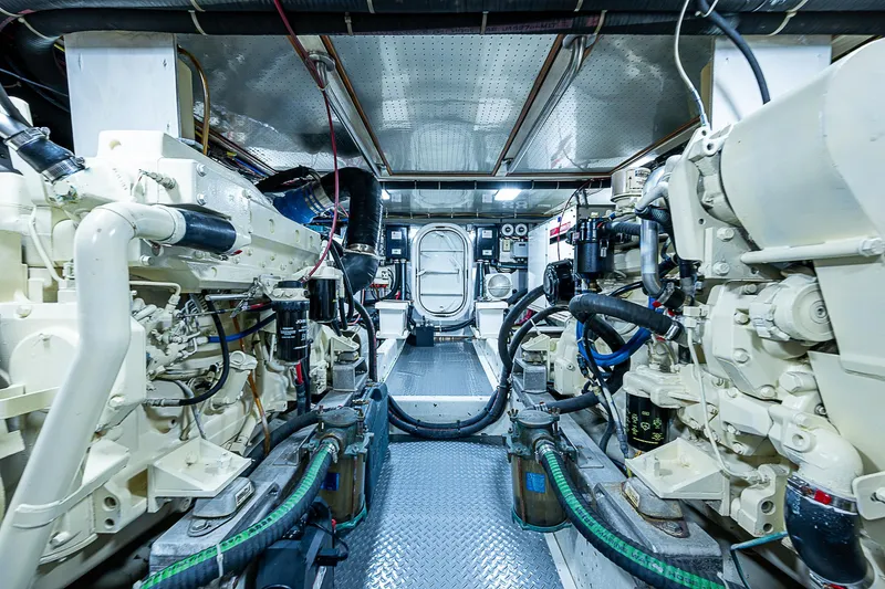 Slide: The Image of Engine room of a 2001 Kadey-Krogen 58 yacht, showcasing dual engines and mechanical systems. - 48