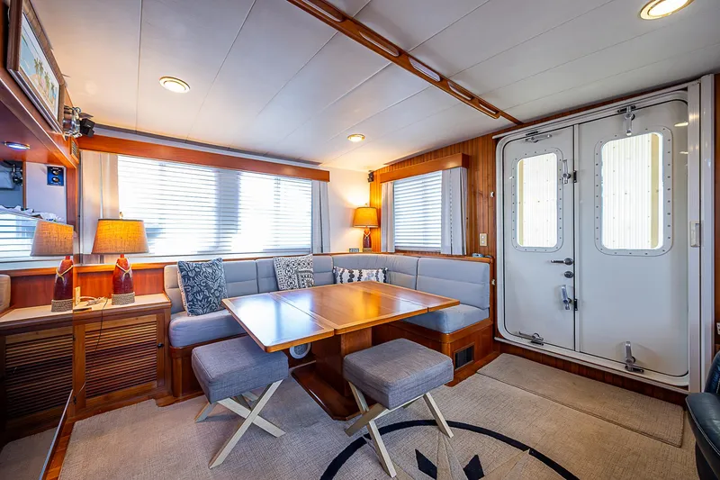 Slide: The Image of Luxurious interior of 2001 Kadey-Krogen 58 yacht with elegant dining area and cozy seating. - 6