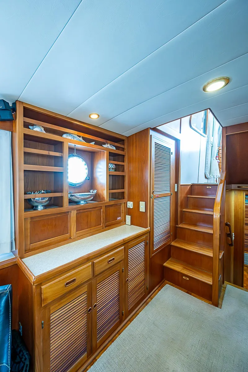 Slide: The Image of Interior of 2001 Kadey-Krogen 58 yacht with wooden cabinetry and staircase. - 9